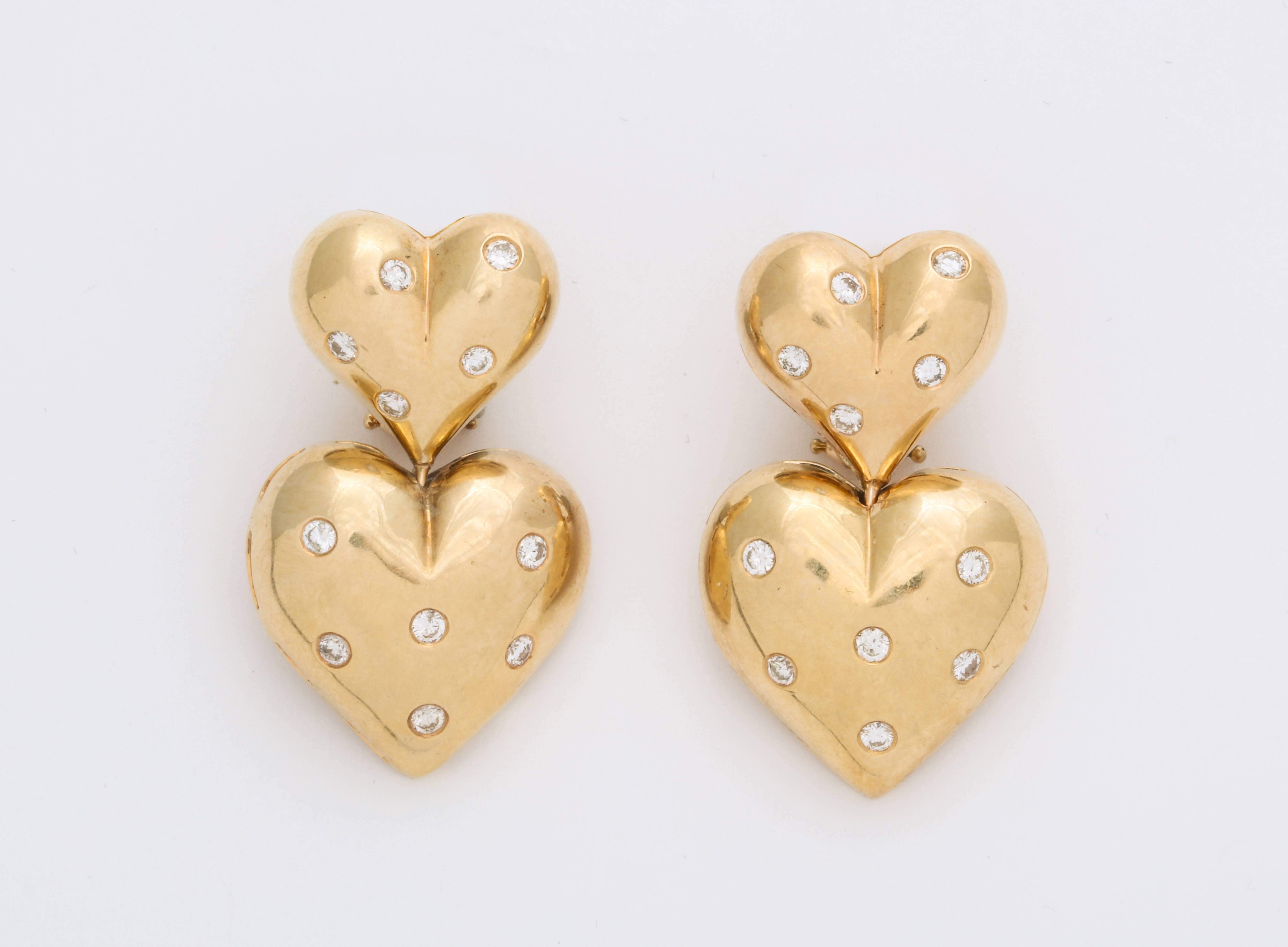 A wonderful pair of twin hearts in 14Kt gold and studded with diamonds signed by Michael Gates