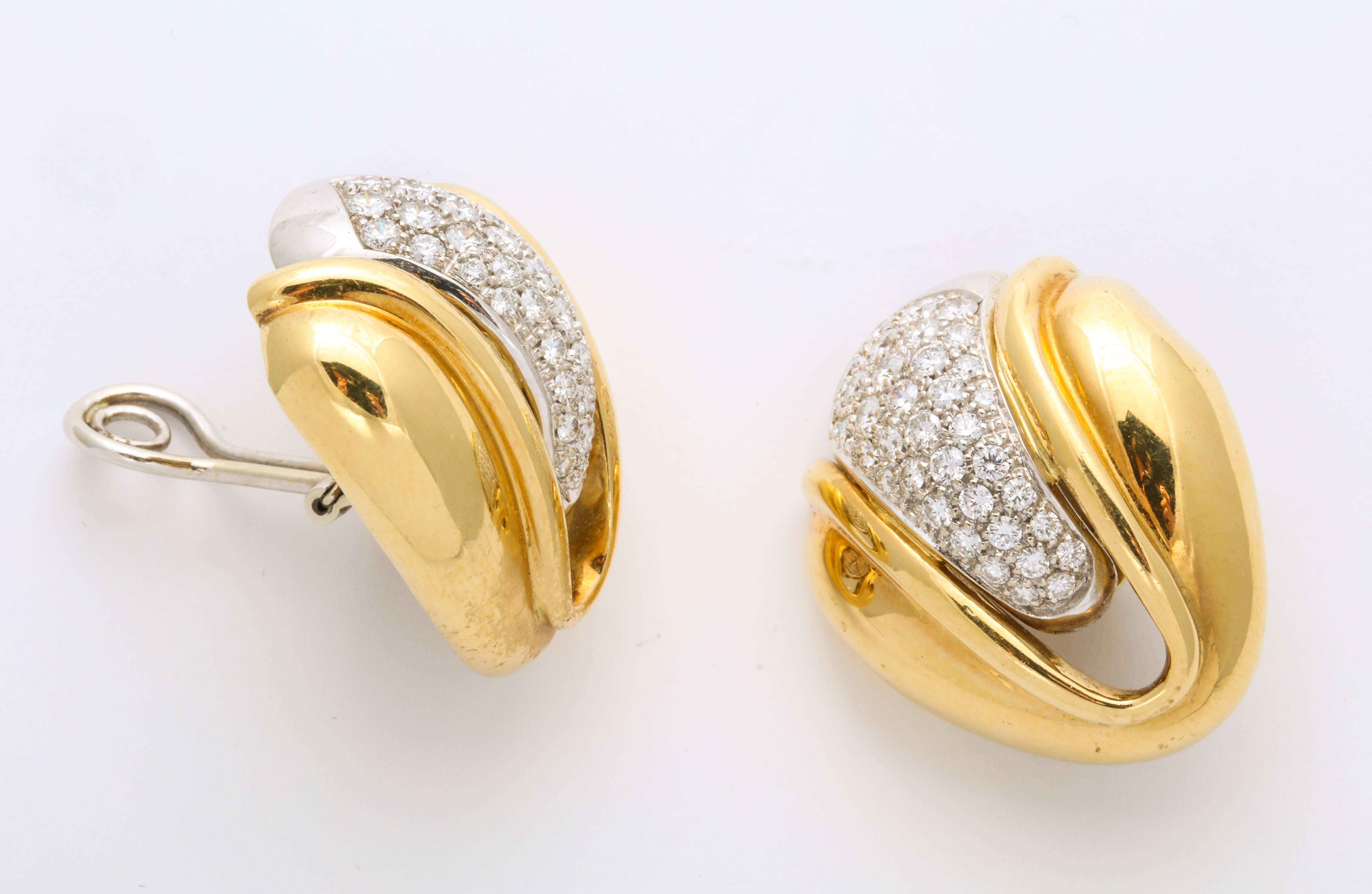 A great pair of stylized petal form earrings in 18K  gold with a significant cluster of diamonds set in platinum in the center   The diamonds are approximately 4-5 cts. Marked Italy and gold mark. They have a clip/post option. 