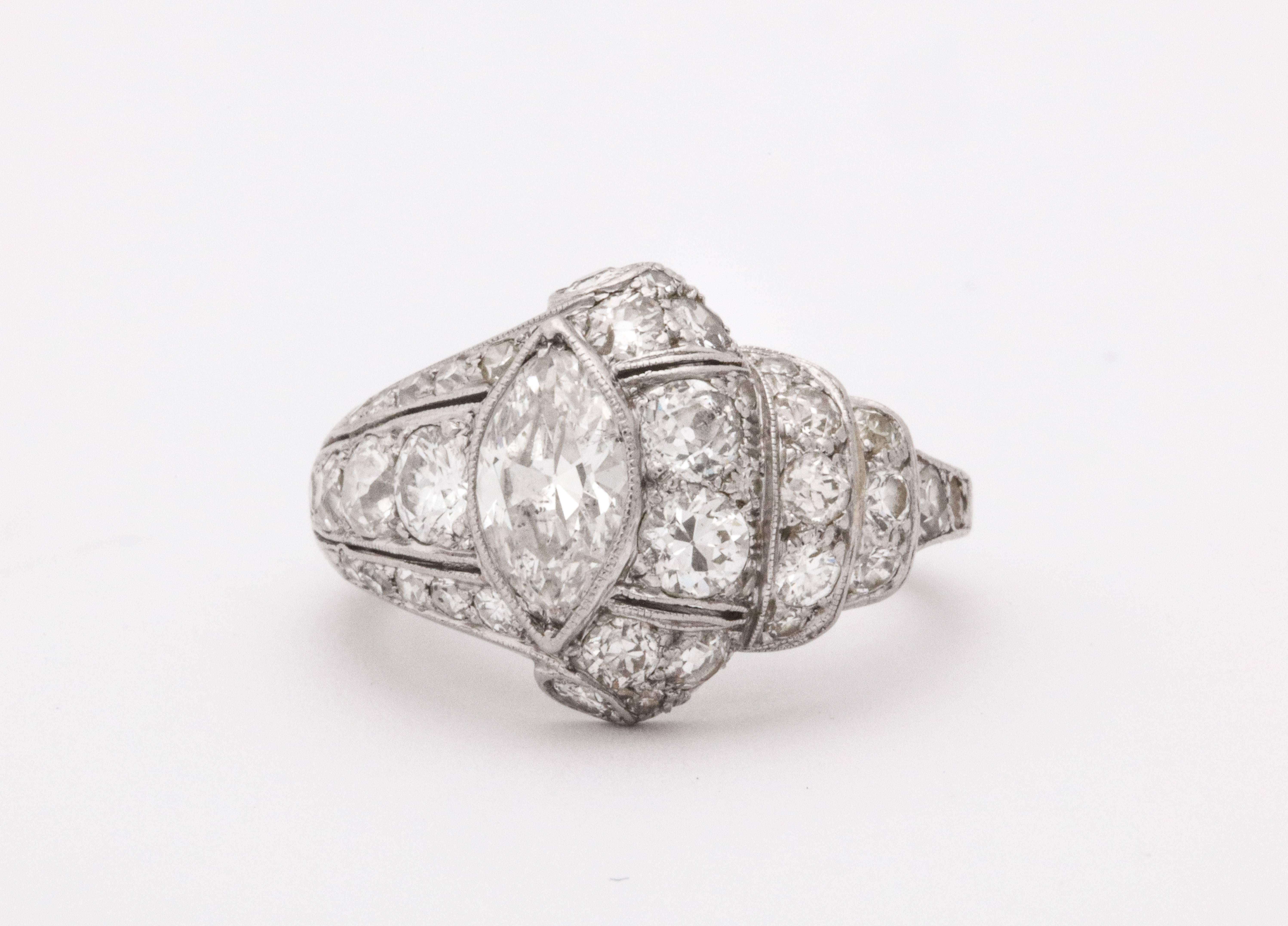 A wonderful Art Deco platinum engagement/cocktail ring with a center marquise 0.80 carat marquise diamond surrounded with 0.80 carat of smaller diamonds. 