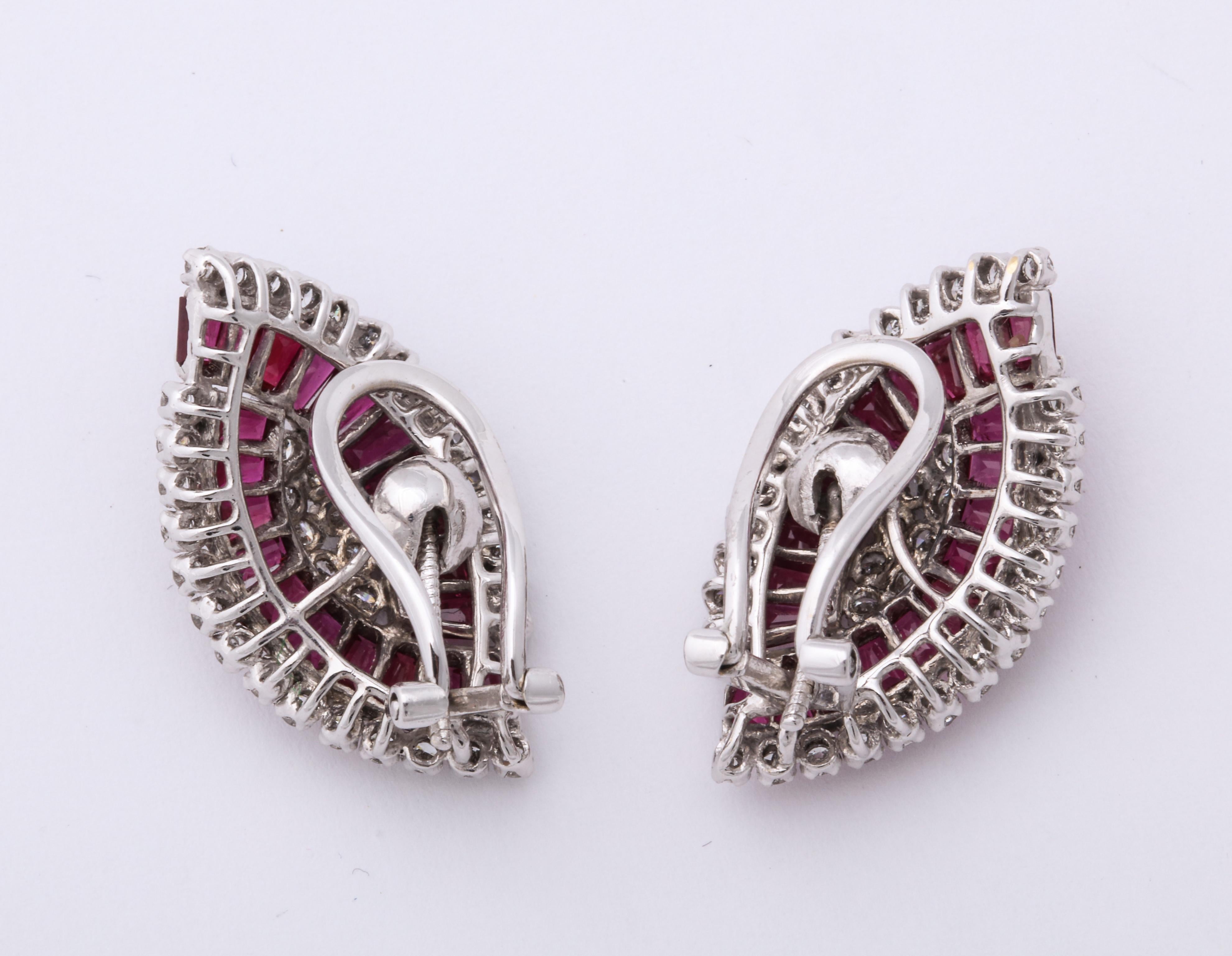 A stunning pair of Natural Ruby and Diamond earrings comprised of4 ct of vine emerald cut   rubies surround 2 ct of quality diamonds set in white gold.  These are exquisitely made with
the ability to wear them as clips or pierced.  