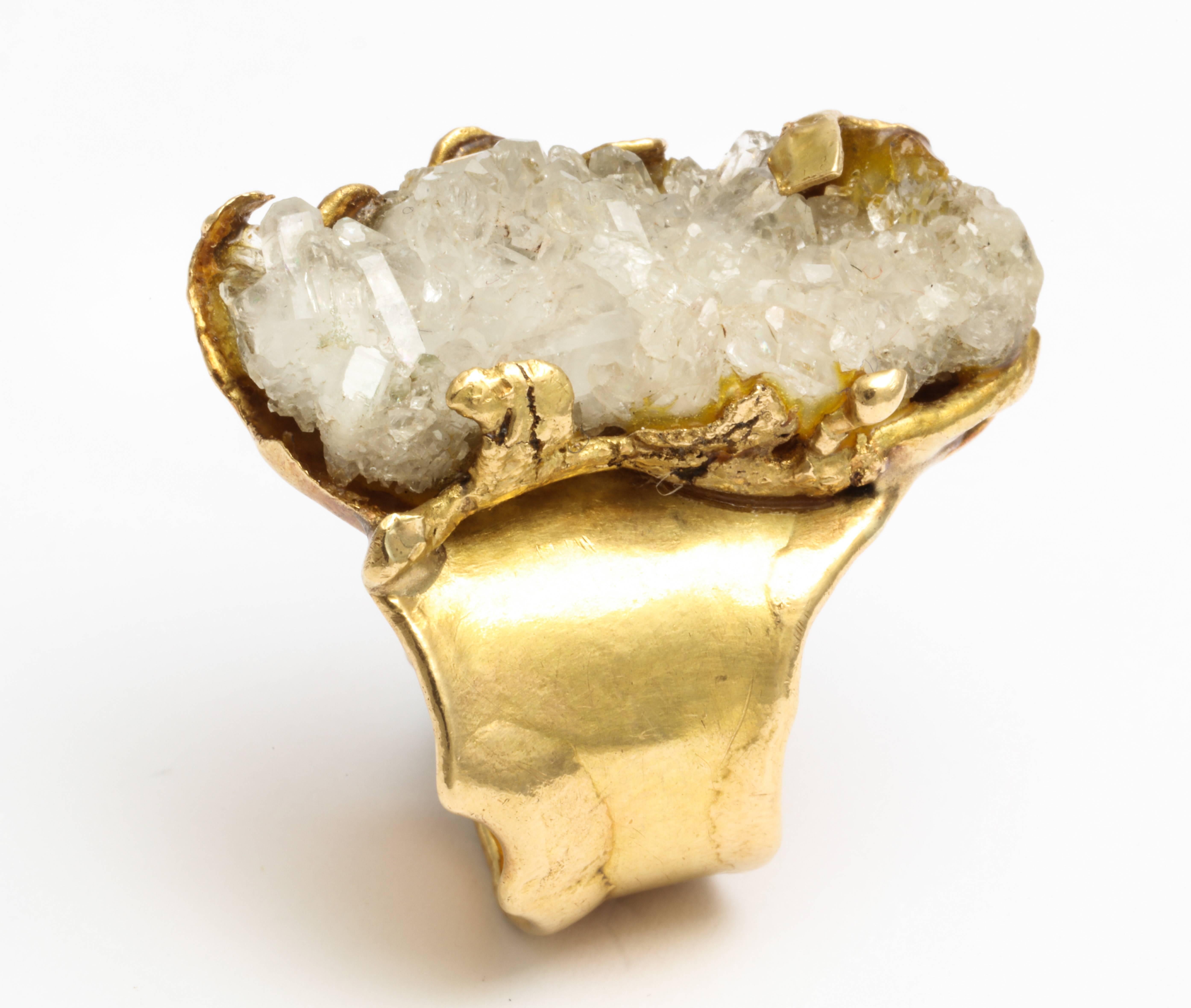 A unique and artistic brutalist ring by Roland Schad. A rutilated quartz stone is set in 18 kt gold artistic modernist design by a well known european jewelry designer.  
The ring is both stunning and comfortable... a statement piece.