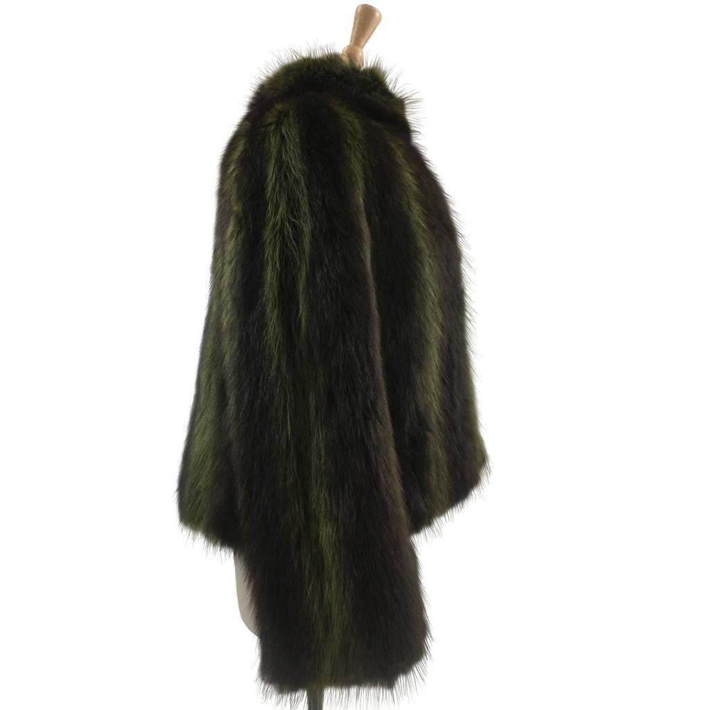 This fabulous sample jacket has wide raglan sleeves, slight swing back; stand up collar and tiny thumb pockets. The green dyed Racoon fur is incredibly sophisticated and current.
Unlined.
No Closure
Maxwell Croft was the premier London Furrier in