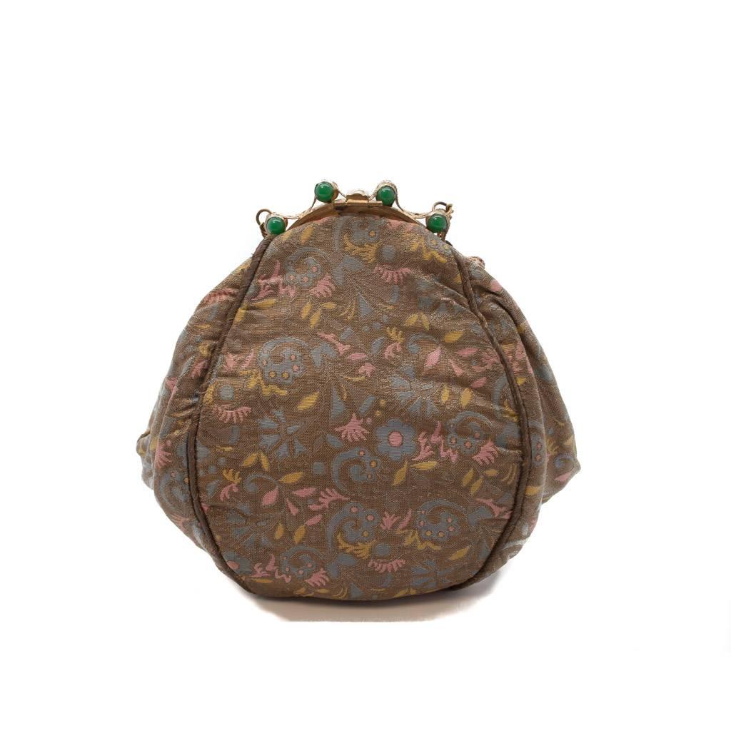 This striking 1930s  bag, , is in silk and metal brocade in dull gold,  blue , pink and yellow. The brocade is reminiscent  of  Italian Renaissance textiles. The shape of the bag  is  the most unusual and appealing  four sided pear shape. The