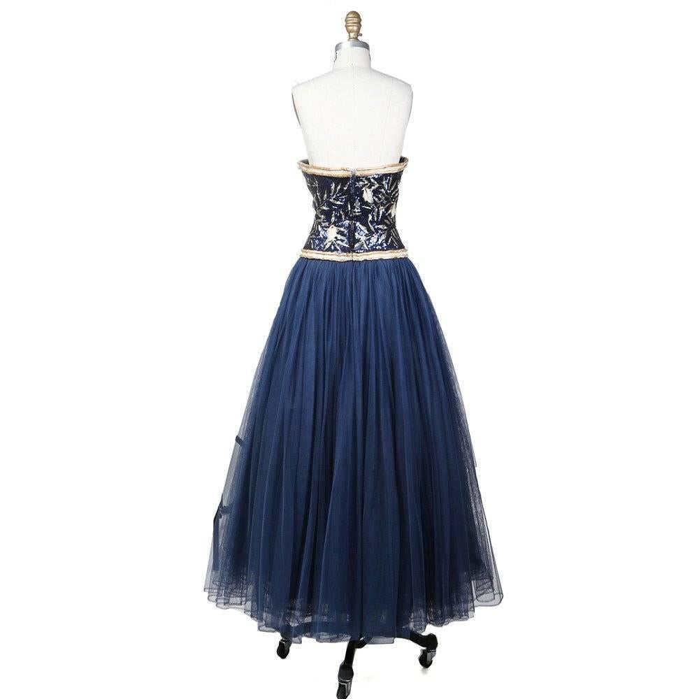 Detail includes full layered tulle and chiffon skirt, a sweetheart neckline, high waist and square beaded trim. 