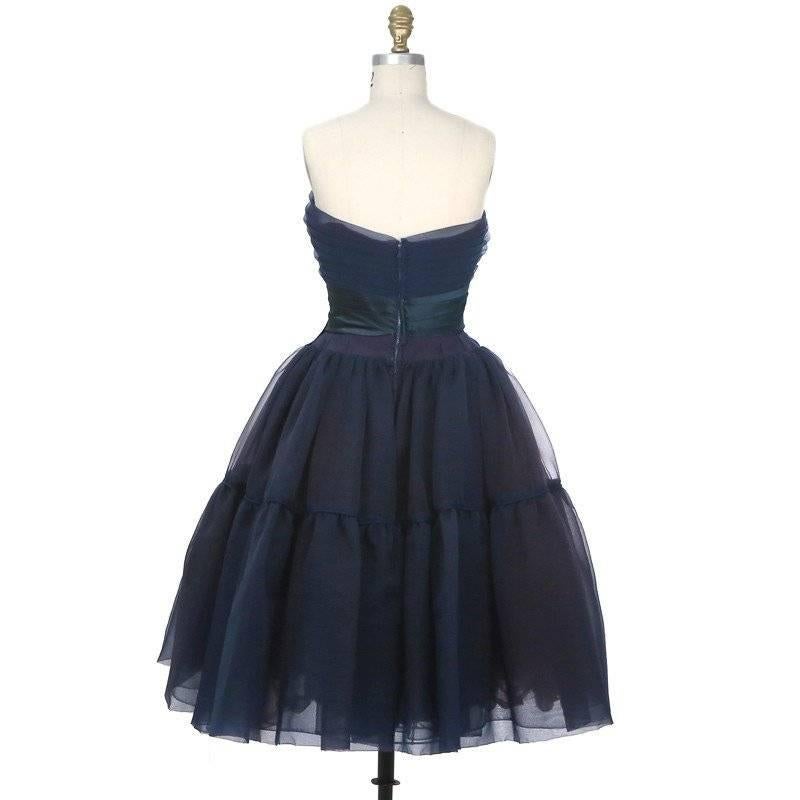 Details include welt seam half way from the skirt length with small piping, very full skirt, pleated strapless bodice, wrap around satin detail at under bust with side bow, and light boning. 