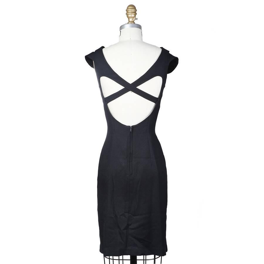 This is a Thierry Mugler dress with criss crossing straps in front as well as the back. It also features curved seam lines to accent the shape of the body, a slight cap at the shoulder, and a subtle bell shaped bottom.  Hidden zipper in back.