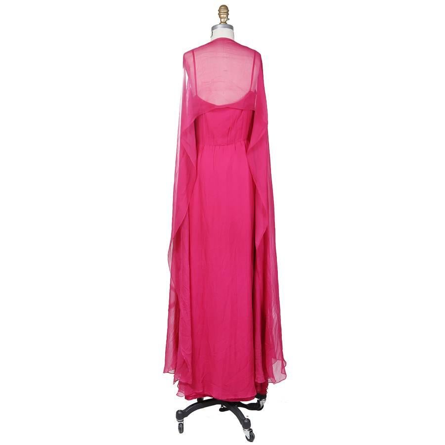 This is a floor length Yves Saint Laurent multi layered pink chiffon dress with spaghetti straps.  The top chiffon layer is attached at shoulders and drapes longer over the sides, acting as a shear flowing shawl.  Has a satin lining, hidden side