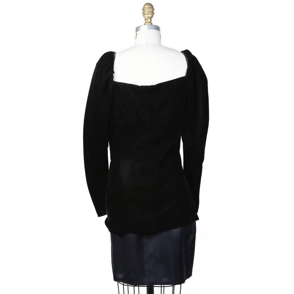 This is a black silk and velvet haute couture dress by Yves Saint Laurent circa 1980s.  It features a sweetheart neckline with velvet gathered around bodice line to create texture.  The puff sleeves taper towards the end and include zipper cuff