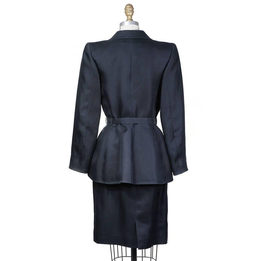 This is a haute couture skirt suit from Yves Saint Laurent circa 1980s.  Some of the the details include etching detail buttons, high set wide lapels, straight cut pencil skirt, front darting turned into seams, darting seam is scalloped at the hem