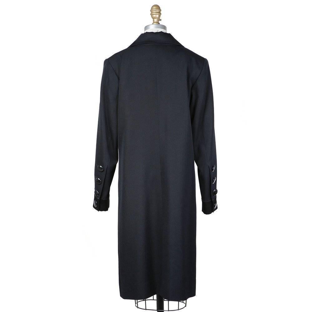 This is a tuxedo dress by Yves Saint Laurent from 1993.  Details include high lapels and 4-side front pockets.  The closures include three pockets and 4 buttons on the sides of sleeves.  