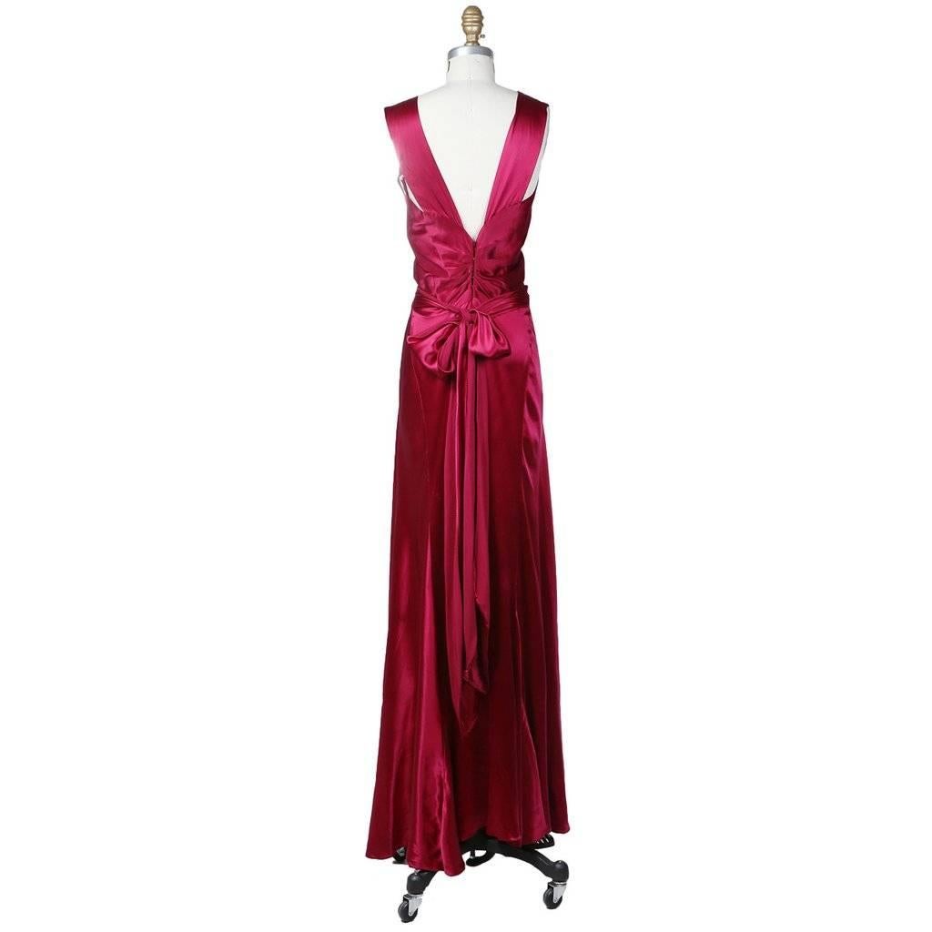 This is a sleeveless floorlength bias cut gown constructed from raspberry silk charmeuse c. 1930s.  It has 2.5