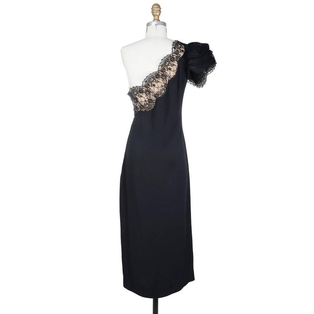 This is a black silk jersey cocktail dress by Bill Blass c. 1980s.  It is a one shoulder design with a tiered lace butterfly sleeve.  There is also lace along the neckline over a layer of nude chiffon.  The closure is an invisible side zipper.  