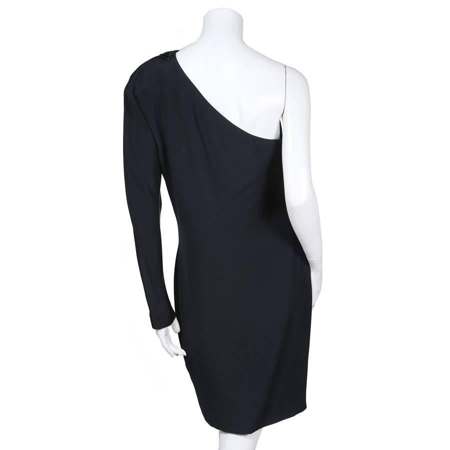 This is a black silk one shoulder cocktail dress by Gucci c. 1980s.  It features a sequin and bead embellishment on the shoulder as well as a dolman style sleeve.  It is satin lined  and the closure is an invisible side zipper.