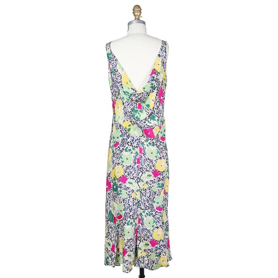 This is a watercolor style floral print dress c. 1940s.  The exact maker is unknown, but the only tag inside reads “NRA CODE / Made Under DRESS CODE AUTHORITY / NPB 016198”  The dress has a cowl neckline that drapes over the bust.  The closure is a