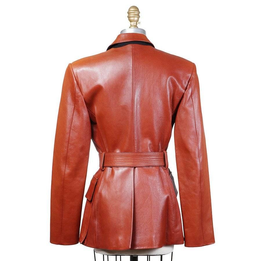 This is a Leather Military Jacket by Jean Paul Gaultier circa 1980s. Details include four pockets, belt and shoulder pads. 