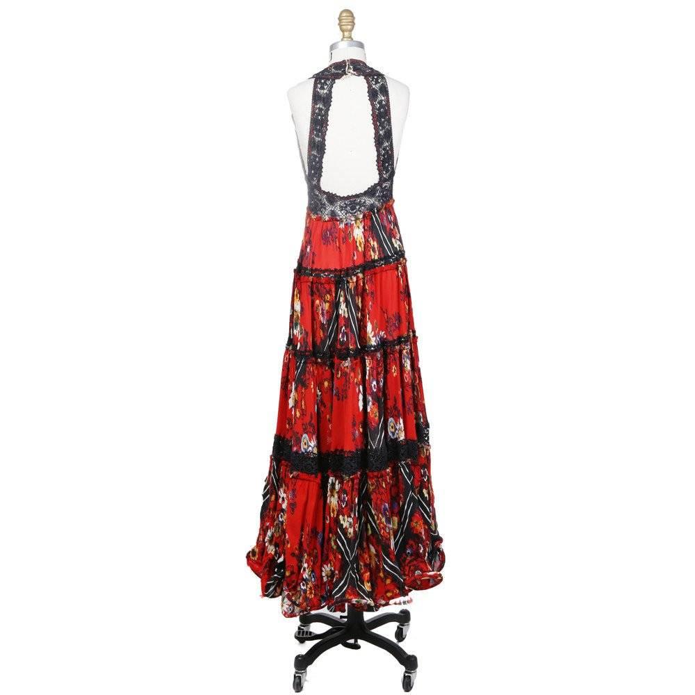 This is a Floral Panel Dress by Jean Paul Gaultier circa 1980s. Details include lace straps in back, lace trim, lace divided printed silk panels, halter back neck, and inserted boning at bottom hem. Closures include a zipper up the side. 