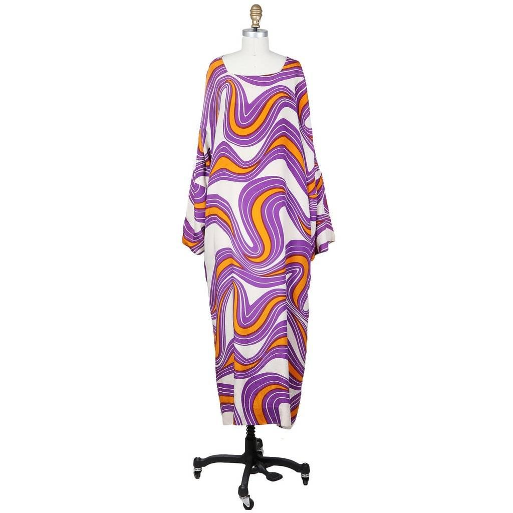 This is a vintage swirl print caftan by Rudi Gernreich c. 1960s.  The dress has two side pockets, long bell shaped sleeves, and a scoop neck line.  100% silk.