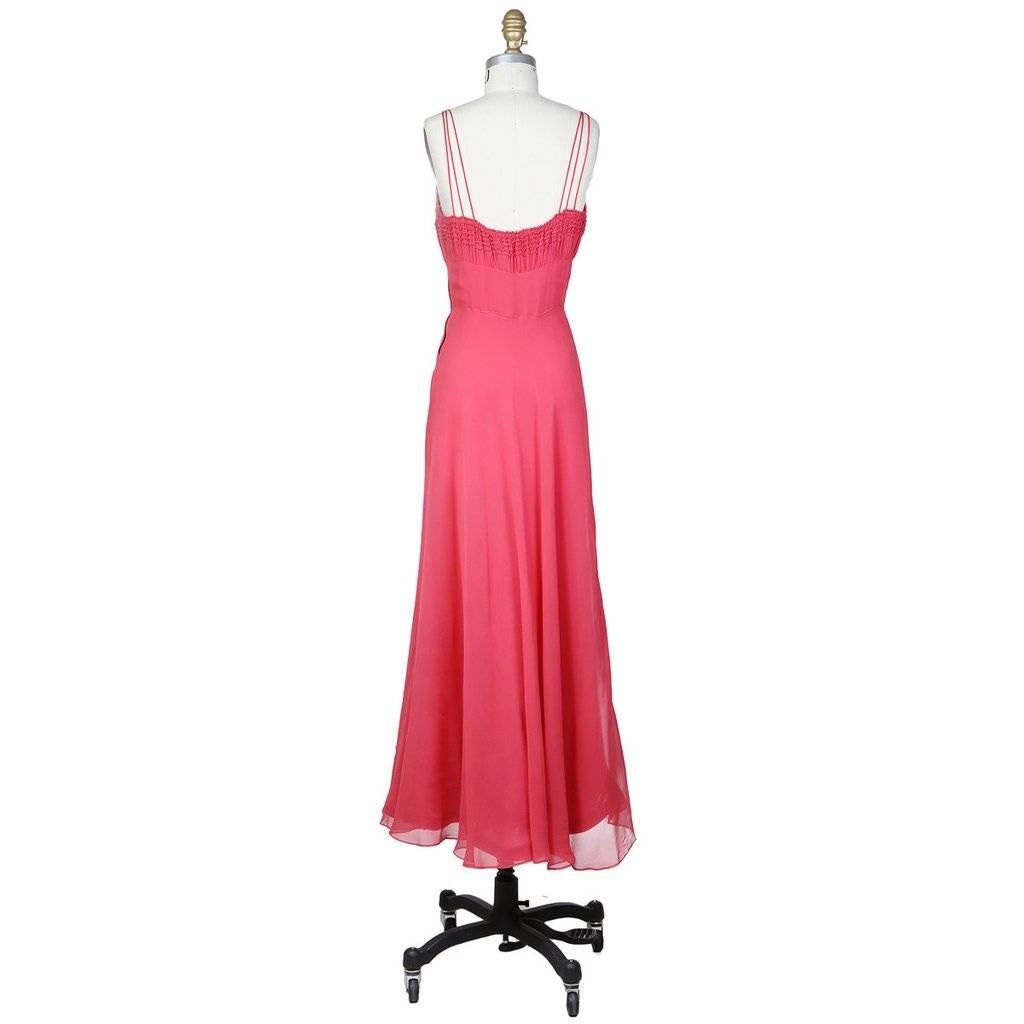 This is coral colored chiffon dress c. 1930s/1940s and the designer is unknown due to it's age.  It features a ruched bust with soft horizontal piping details and triple spaghetti straps on each side.  The skirt consists of multiple chiffon layers