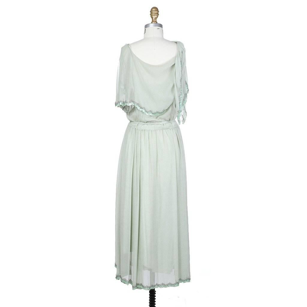 This is a sleeveless chiffon sheath dress by Karl Lagerfeld under the label Chloe c. 1970s.  The mint colored chiffon has a subtle white stingray pattern to it.  The dress features spaghetti straps and a shawl to cover the shoulders, creating a cap