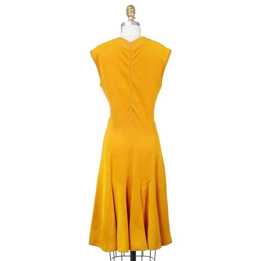 This is a sleeveless dress by Azzedine Alaia c. 1980s.  It's constructed from a soft viscose stretch fabric that feels like a terrycloth, giving the dress a sporty accent. It also features a ribbed crew neckline, A line skirt, and curved seams in