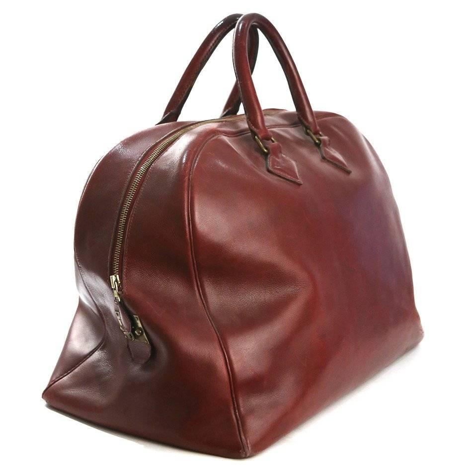 This is a dark red leather large travel bag by Hermes c. 1940s.  It features antique gold hardware and a snap zipper lock on the side of the bag.  
Length is 13"
Height is 18"
Width is 10"
Shoulder drop is 6"