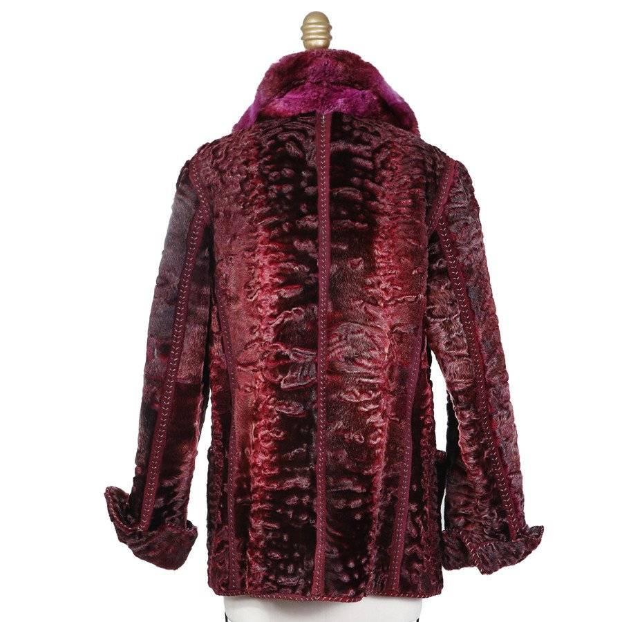 This is a recent multi tonal purple broadtail coat by Fendi.  It features a fur collar and purple suede trimmed seams with exposed stitching.  Another detail is the two front waist pockets.  The closure is a single hook an eye closure in the front