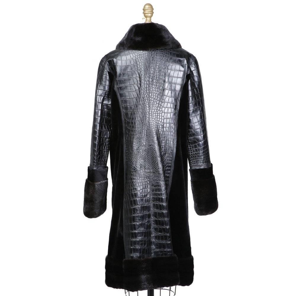 This is a recent black patent alligator coat with mink trim by Oscar De La Renta.  It features a large mink collar, wide mink cuffs, and has no closures.  It retails at $34,000.  
Shoulder to shoulder is 19"
Sleeve length is 26"
