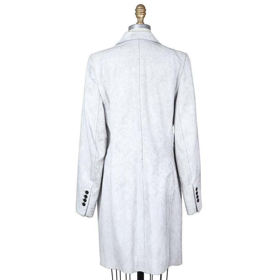 This is a leather coat by Ann Demeulemeester. It's made from black leather white a white crackle texture finish.  It has a two button single breast closure, lapel collar, and rayon lining. Made in Belgium.
Shoulder to shoulder is 15.75"
Sleeve