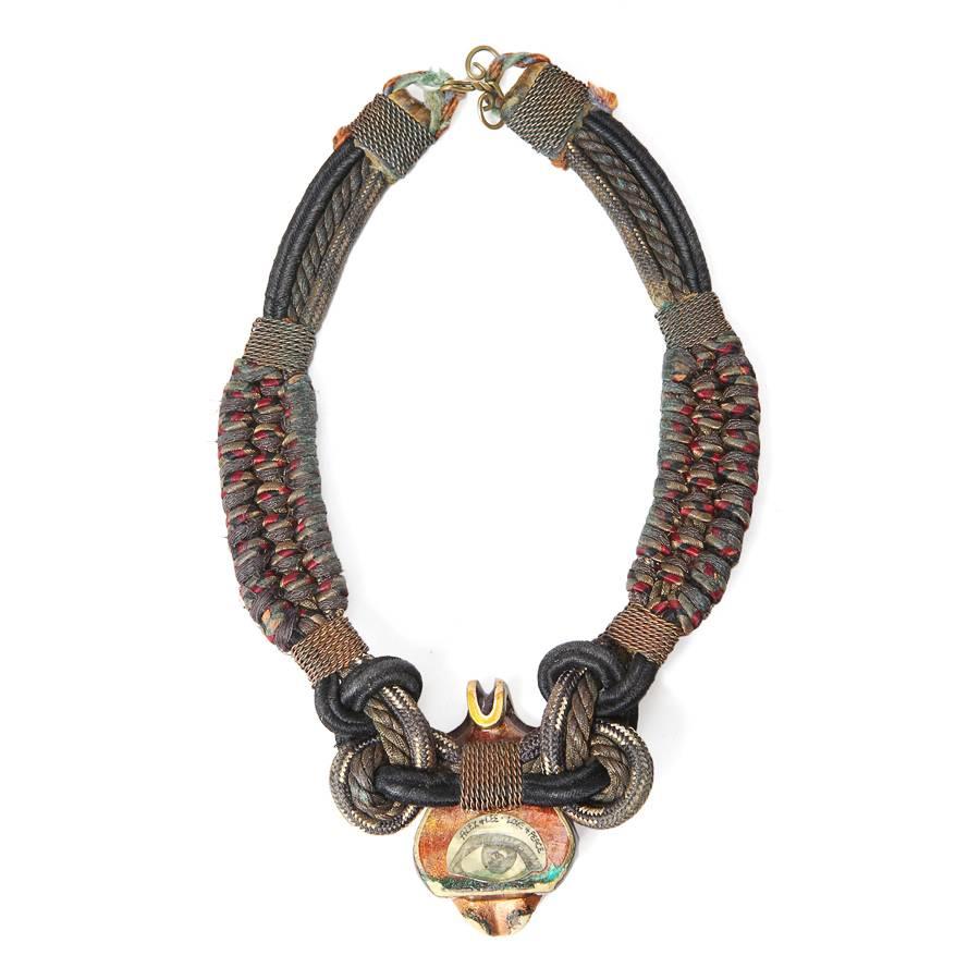 This is a choker crafted by Alex and Lee from the 1970s.  It features a twisted and braided rope chain with an abstract owl ornament in front.  Alex and Lee were artists and renegade jewelers from the bohemian movement of the 1970s and each piece
