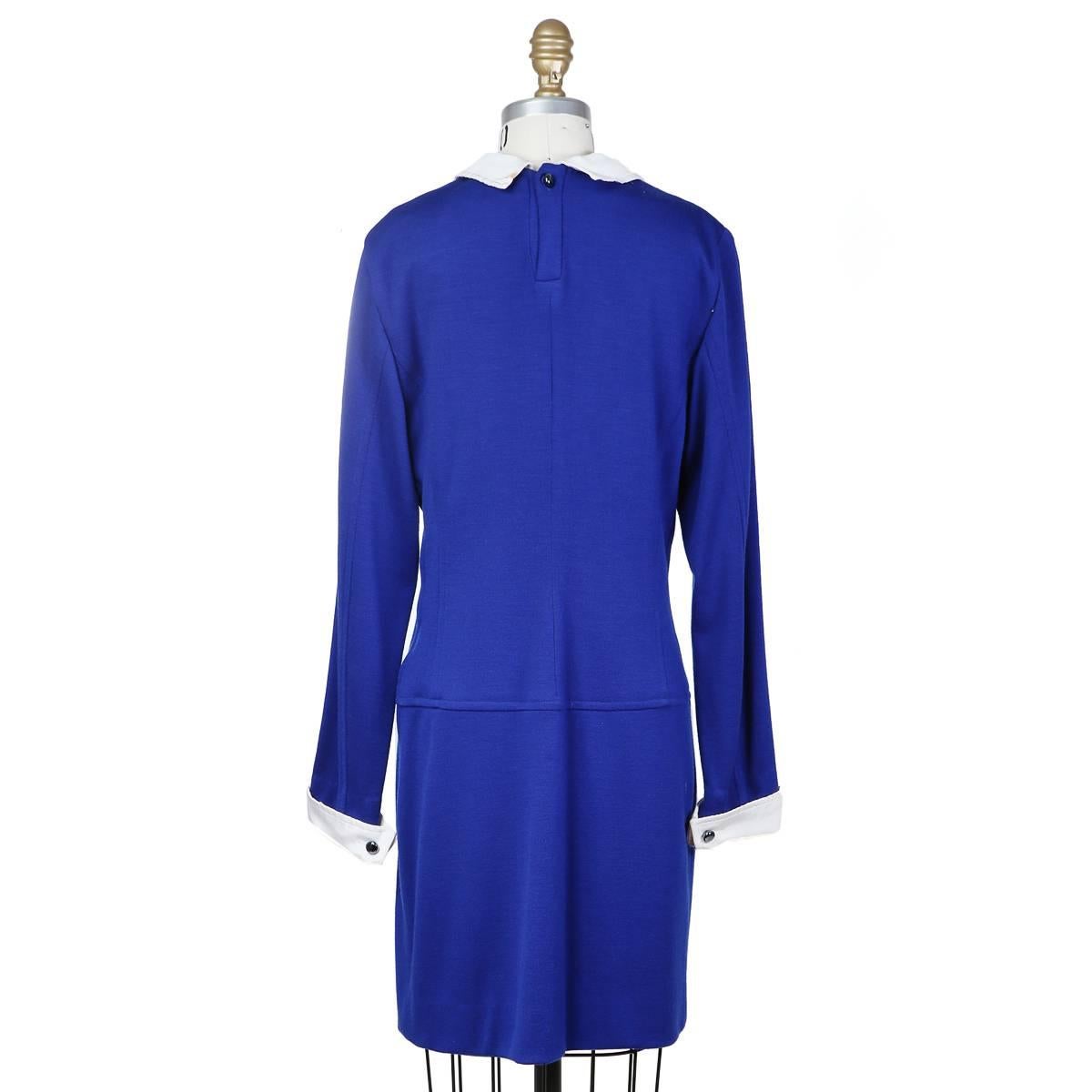 This is a long sleeve dress by Gucci from the 1970s.  It's made from a cobalt blue wool and has detachable white cotton/rayon collar and cuffs.  The closure is a side zipper and a top button and loop closure in back at the neck.  The dress is also