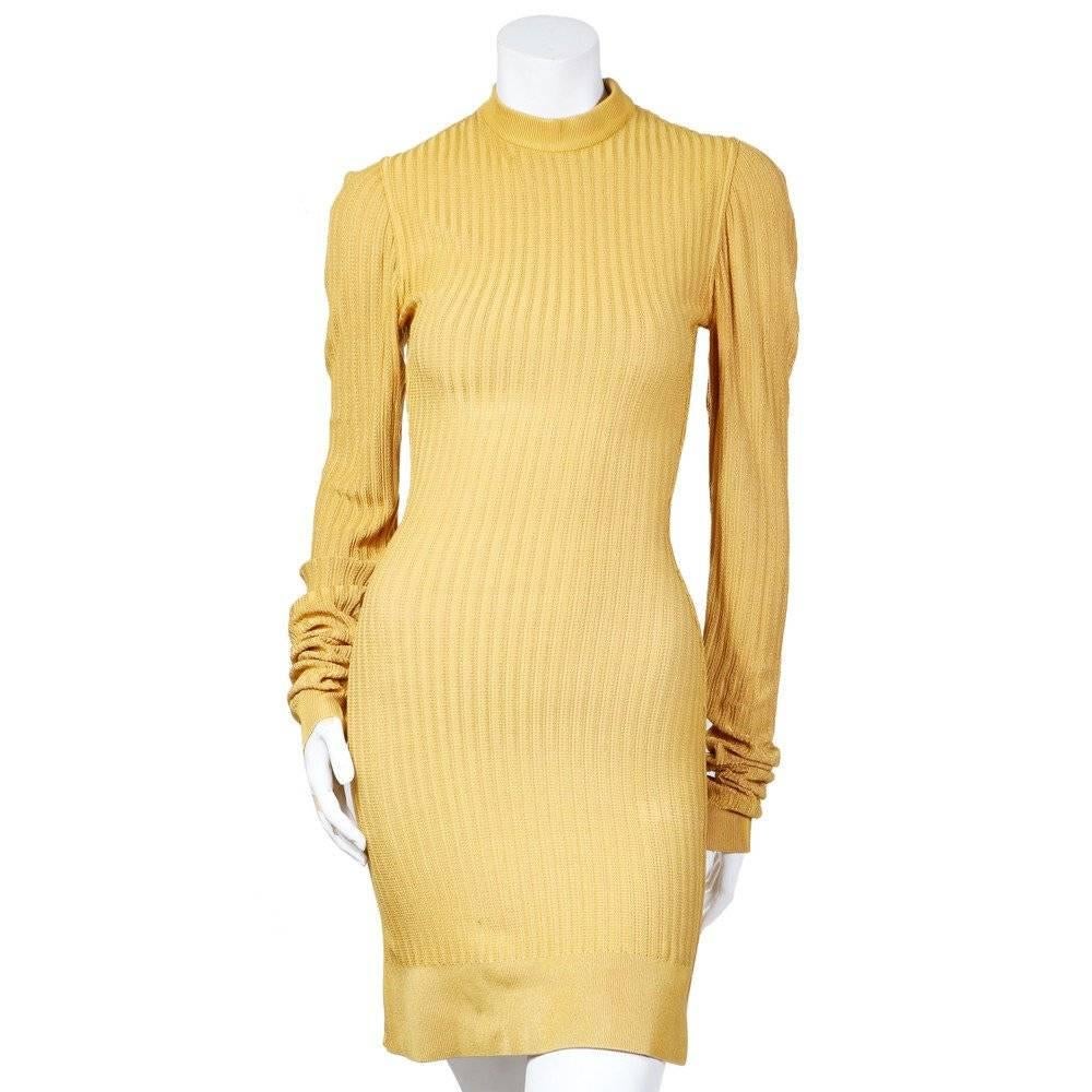 This is a bodycon dress and cardigan by Azzedine Alaia c. 1980s.  It's made from from a stretch ribbed knit and features a crew neck collar and ribbed hem and cuffs.  The cardigan is cropped and has dolman sleeves and a 6 button closure. 
Shoulder