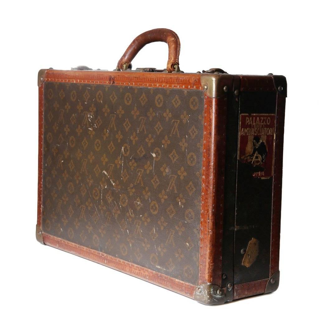 This is a briefcase by Louis Vuitton c. 1900s. It features leather trim and handle, two metal clasp closures and key.  The inside is lined in linen and the exterior features the classic LV monogram.
L 19.75" x W 12.75" x H