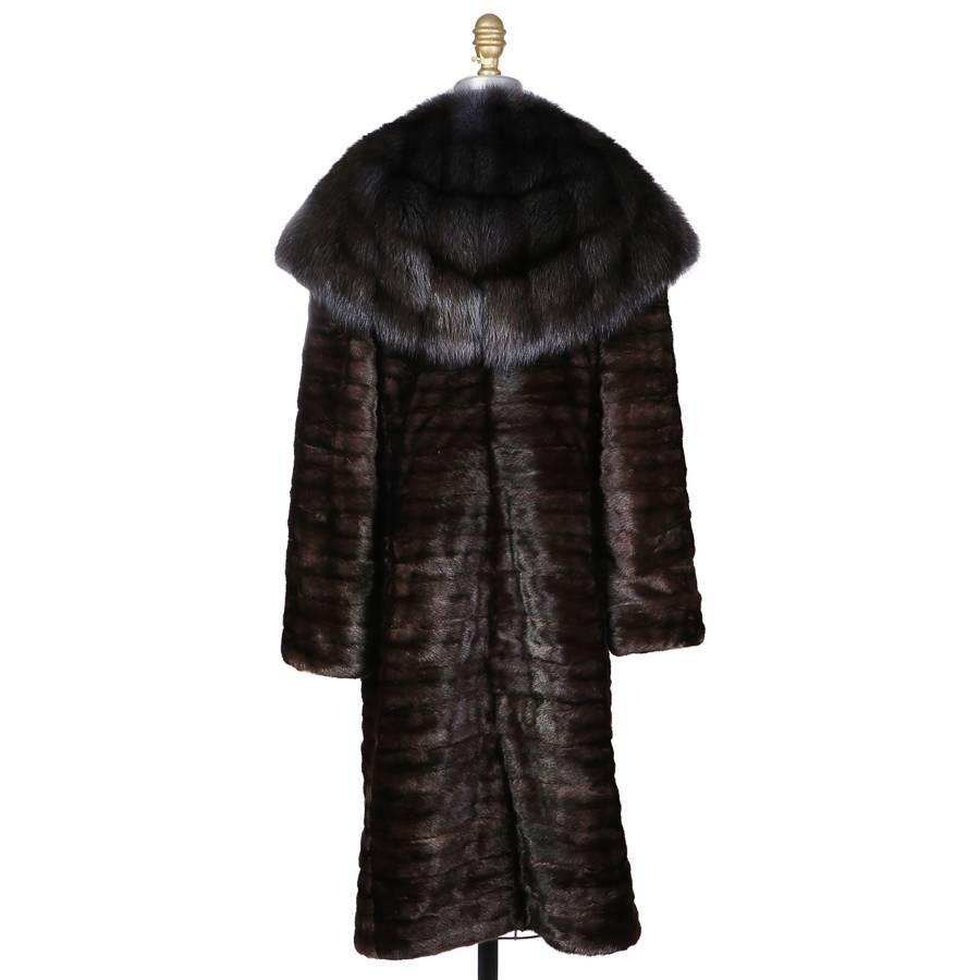 This is a contemporary fur coat by J. Mendel.  It is made from chocolate brown dyed ermine.  It features a large collar and hood.  The closure is a set of front hook and eye closures.
Shoulder to shoulder is 17"
Sleeve length is 24"
