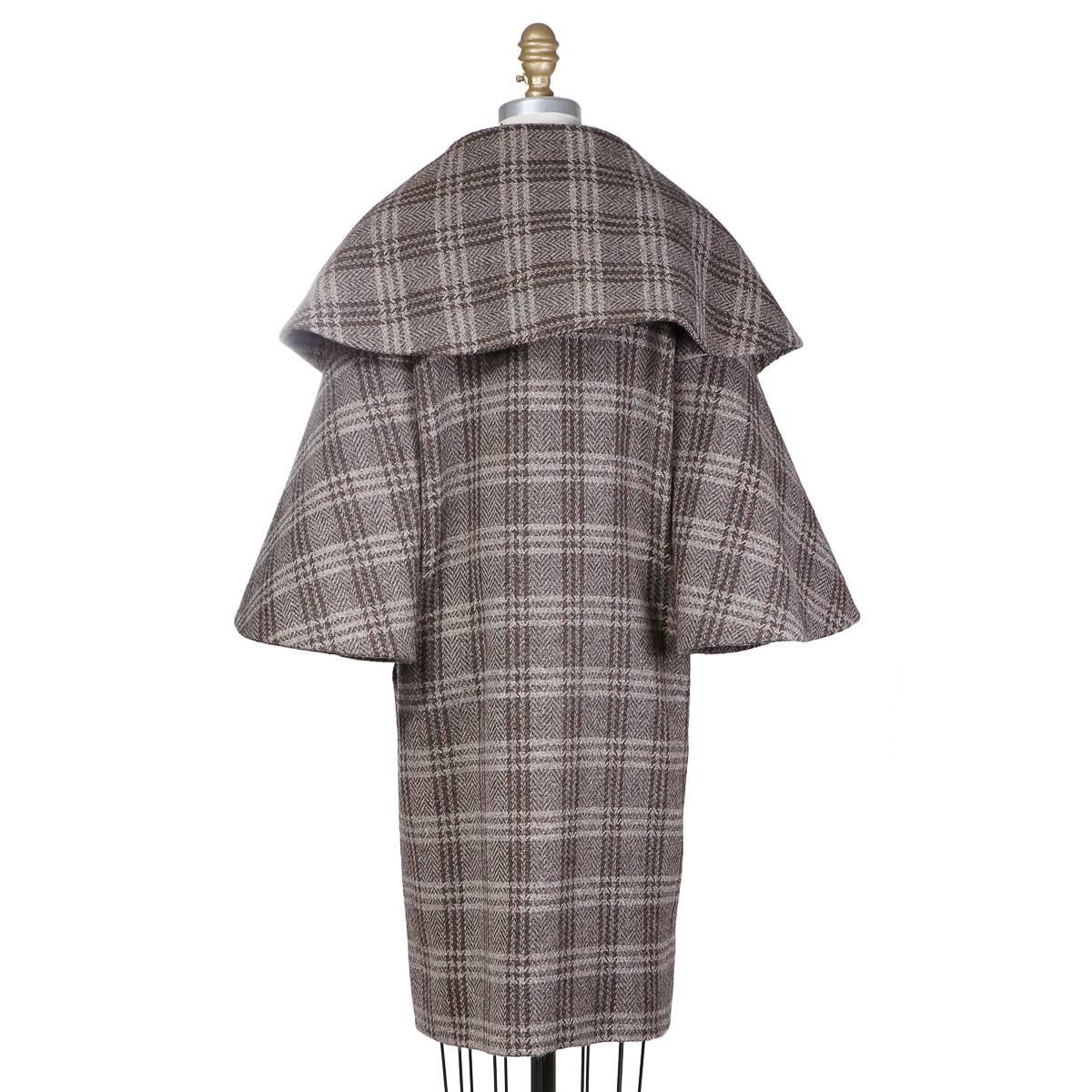 This is a wool coat by Pierre Cardin c. 1960s.  It features a plaid pattern and an oversized collar and flared 3/4 sleeves.  
Shoulder to shoulder is 14.5"
Sleeve length is 19.5"