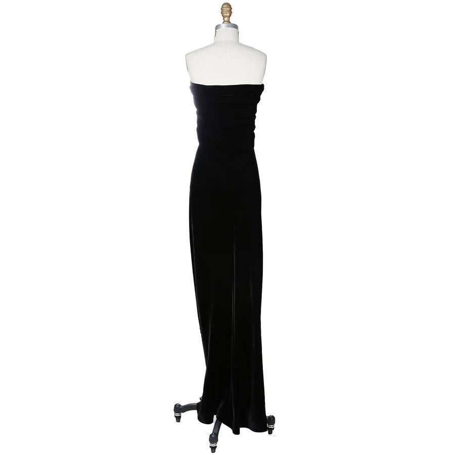 This is a strapless dress by Halston c. 1970s. It is made from black velvet and features a front knot over the bust.  A tag inside reads "ILGWU: Int'l Ladies Garment Worker's Union, Made In U.S.A."
