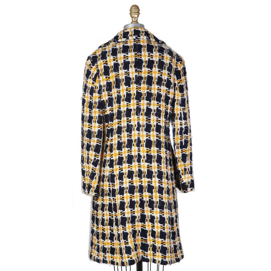 This is a double breasted coat by Junya Watanabe Commes Des Garcons from 2001.  It is made from woven wool threads to created a plaid pattern.  It features a cotton lining and two outside waist pockets.  Made in Japan.
Shoulder to shoulder