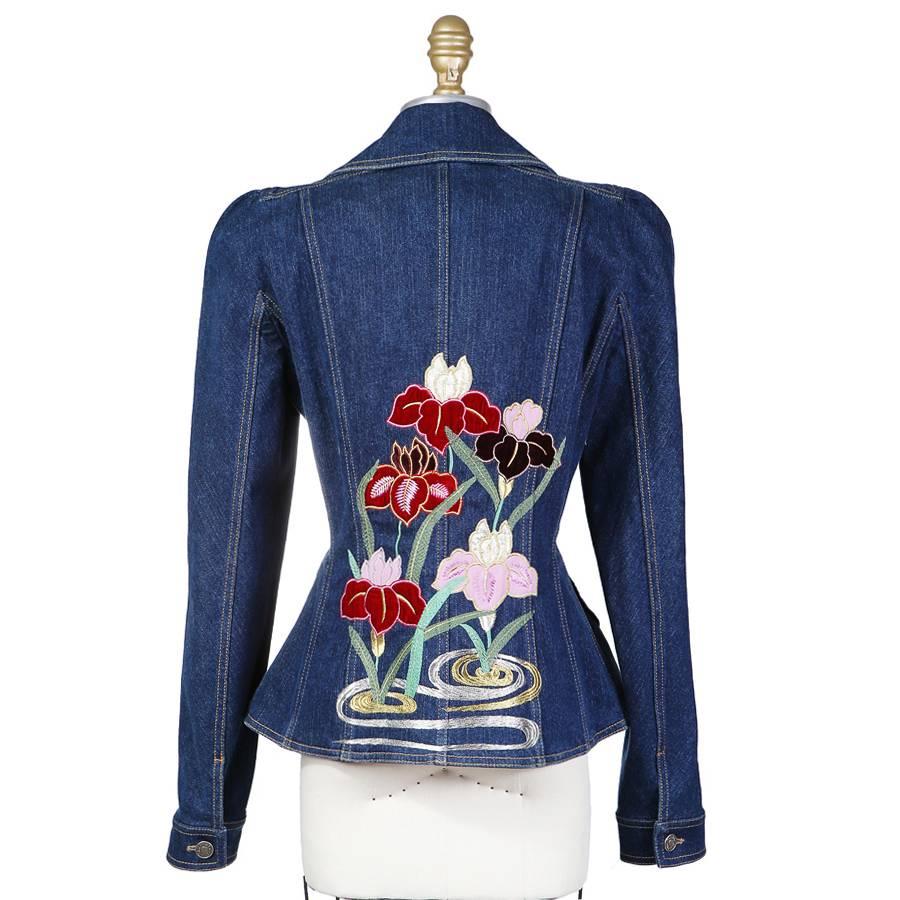 This is a medium blue denim blazer by John Galliano for Christian Dior c. early 2000s.  It features heart shaped pockets and floral applique with embroidery on the back.  Made in Italy.
