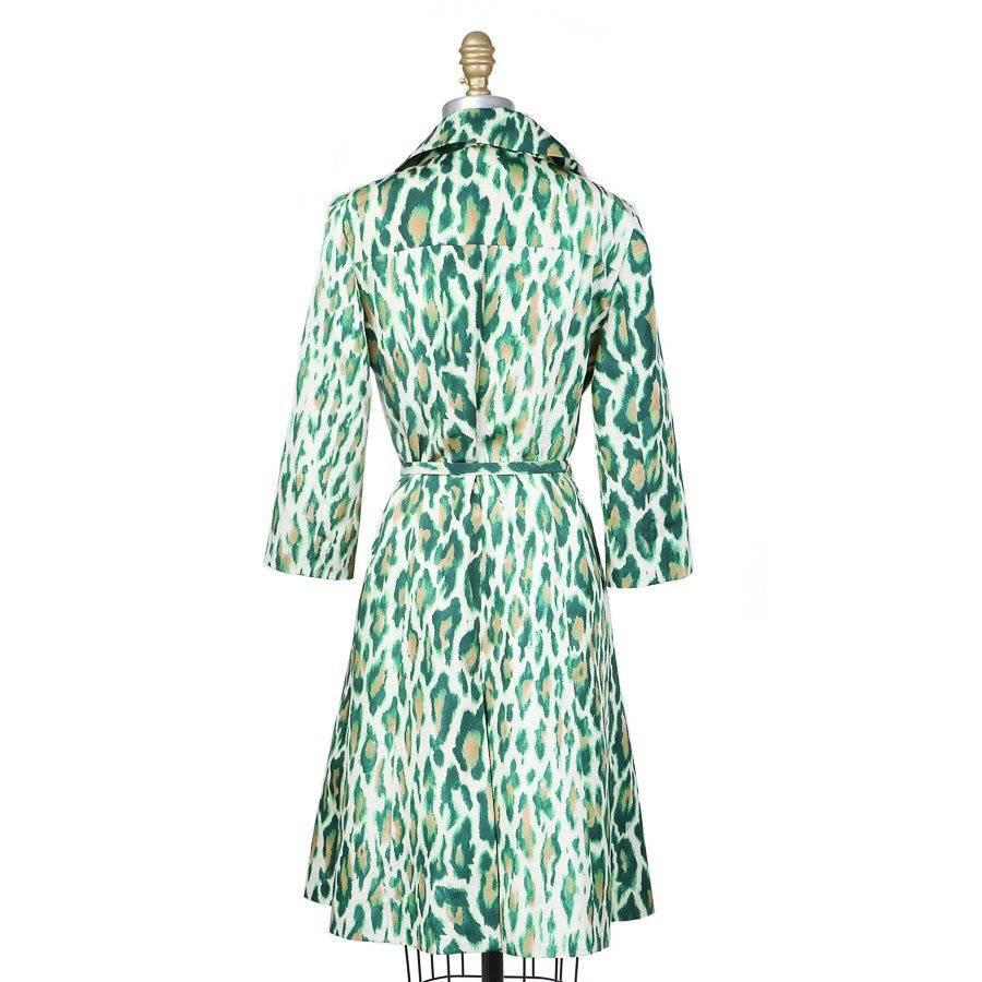 This is a green leopard print trench coat by John Galliano for Christian Dior from the Resort 2008 collection.  It comes with a matching belt that has a jewel embellished buckle. The jacket also features two hidden front pockets, a double breast