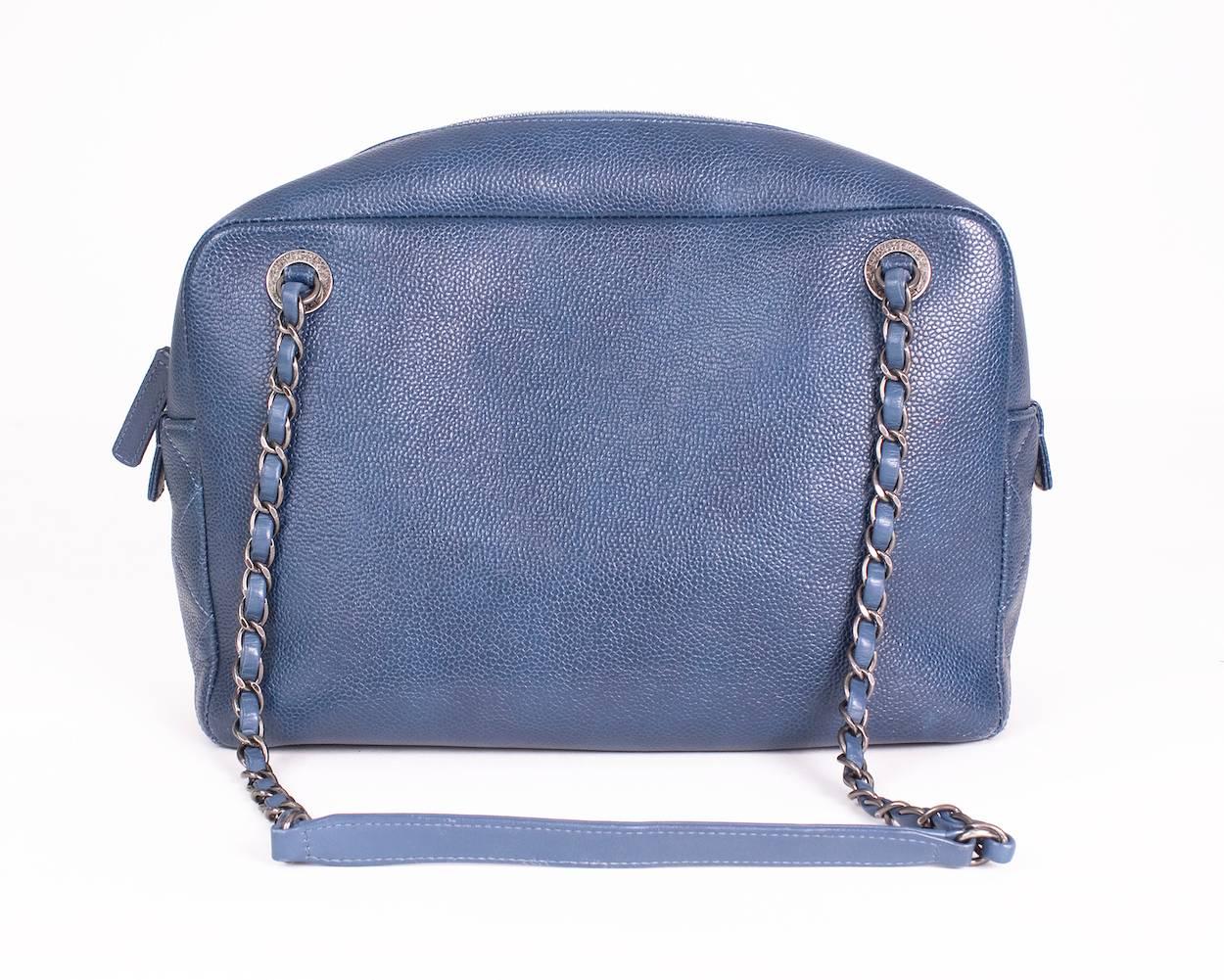 This is a blue leather Chanel camera bag from 2016.  It is made from quilted and pebbled leather and features an outside flap pocket with a magnetic snap closure as well as antique silver hardware. 
11