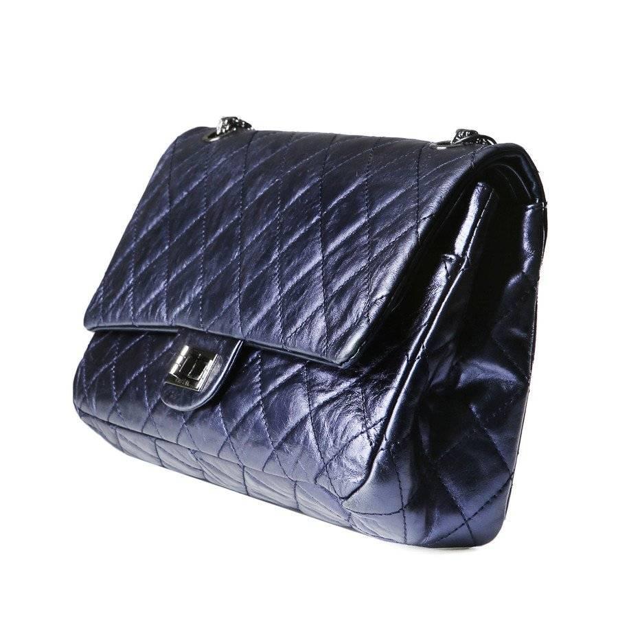 This is a shoulder bag by Chanel from 2008.  It is made from quilted metallic dark blue leather.  It features a double flap closure with a twist lock.
12