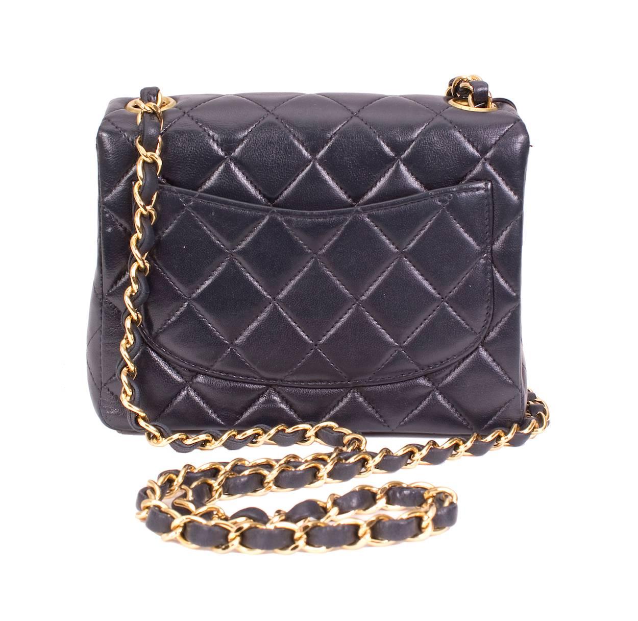 This is a navy blue quilted lambskin bag by Chanel from the year 2000.  
The dimensions are 6.5