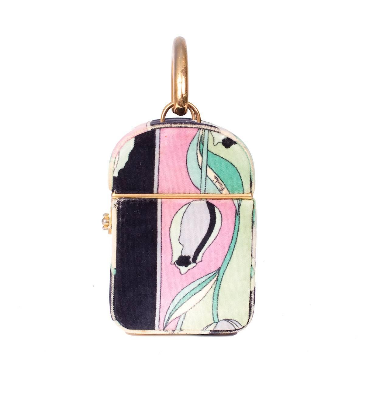 This is a velvet handbag by Emilio Pucci c. 1960s.  It features a signature Pucci print.  
The dimensions are 4.75