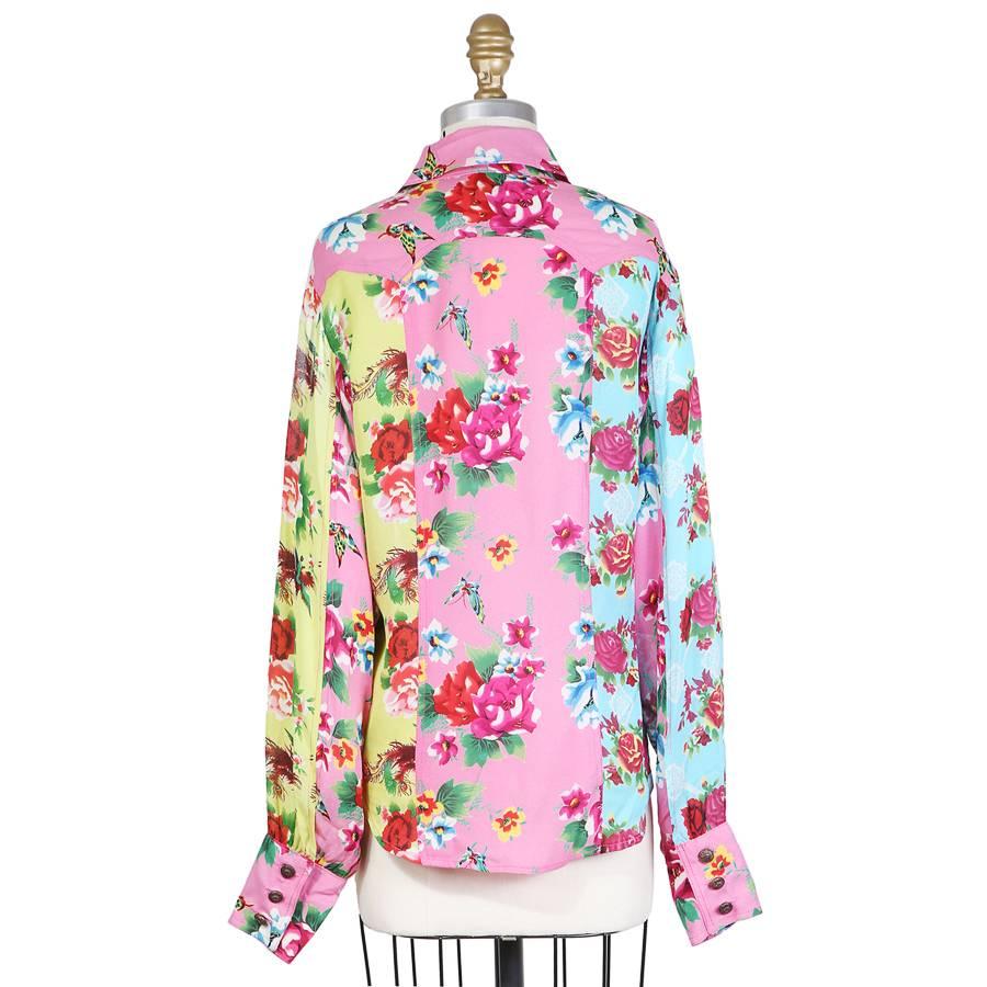 This is a floral print collared shirt by Todd Oldham from spring 1995.  It features vertical panels in different color floral prints.  Button closure down the front.
15.5" shoulder to shoulder
25" long sleeves