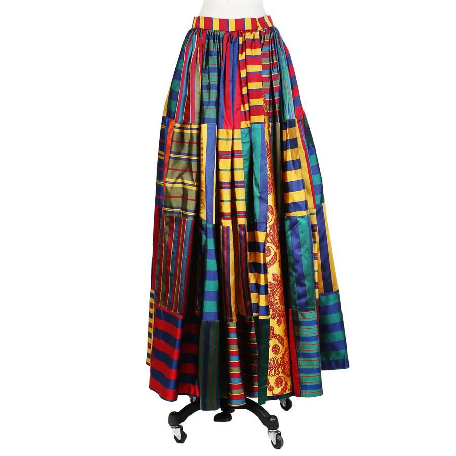 This is a ballgown skirt by Todd Oldham from fall 1992.  It features a patchwork design of various stripes and colors.  The closure is a large hook and eye on the back of the waistband.  