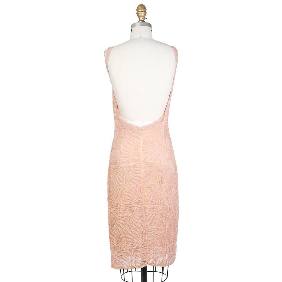 This is a blush pink beaded cocktail dress by Todd Oldham from .  The base fabric is chiffon and it is covered in a beaded squiggle pattern.  The closure is an invisible zipper down the center back.