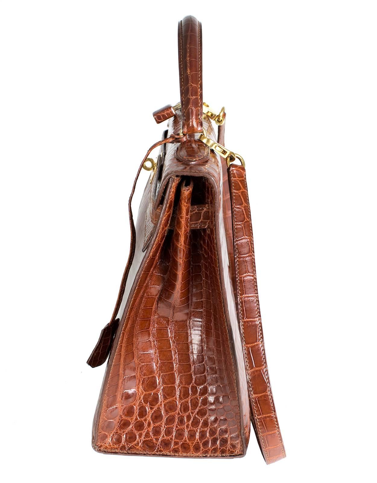 This is a cognac crocodile Kelly bag by Hermes from 1991.  Lock and key included. 

12.5" x 4.5" x 8.5"
3" handle drop
34" shoulder strap length