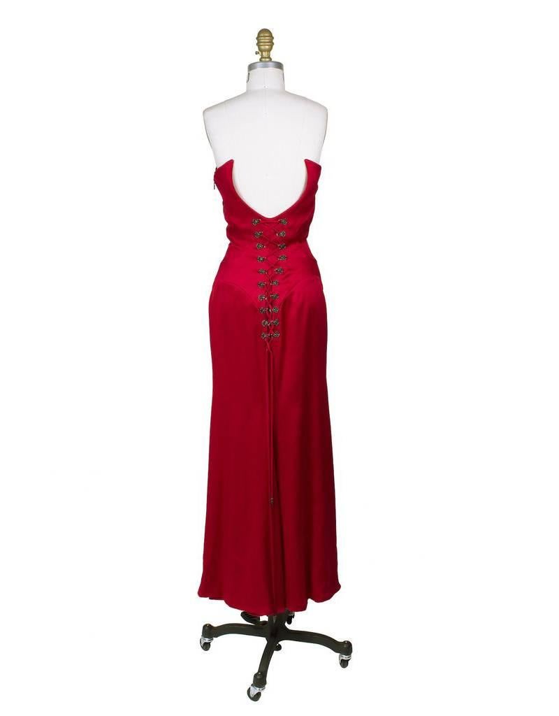This is a red silk satin strapless gown by Gianni Versace.  Features a lace up corset detail in back.  