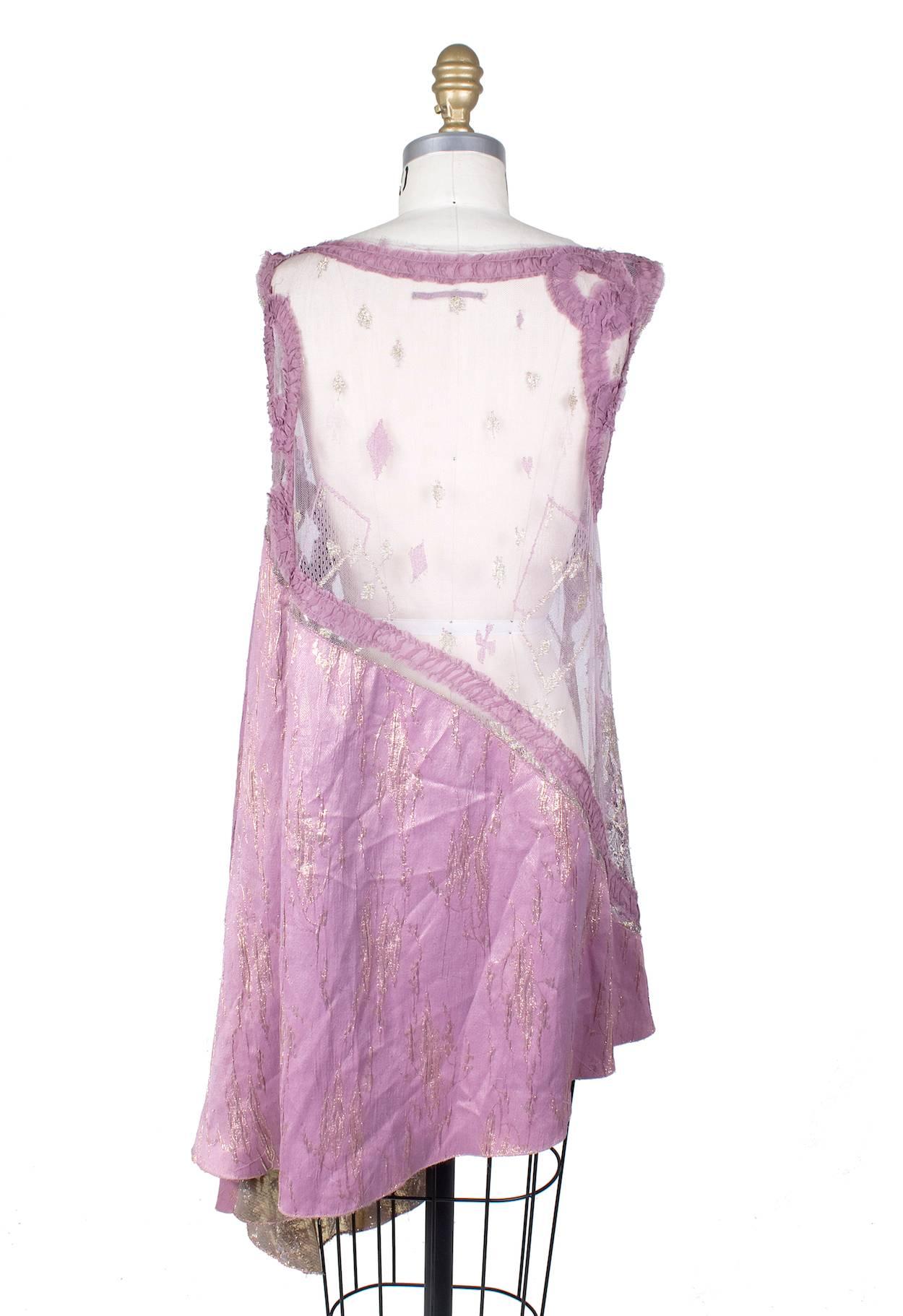 This is a top by Jean Paul Gaultier c. 2000s.  It features purple lace and sheer mesh with subtle gold detailing.  It is also long enough to be worn as a trapeze/tent style dress.  

15