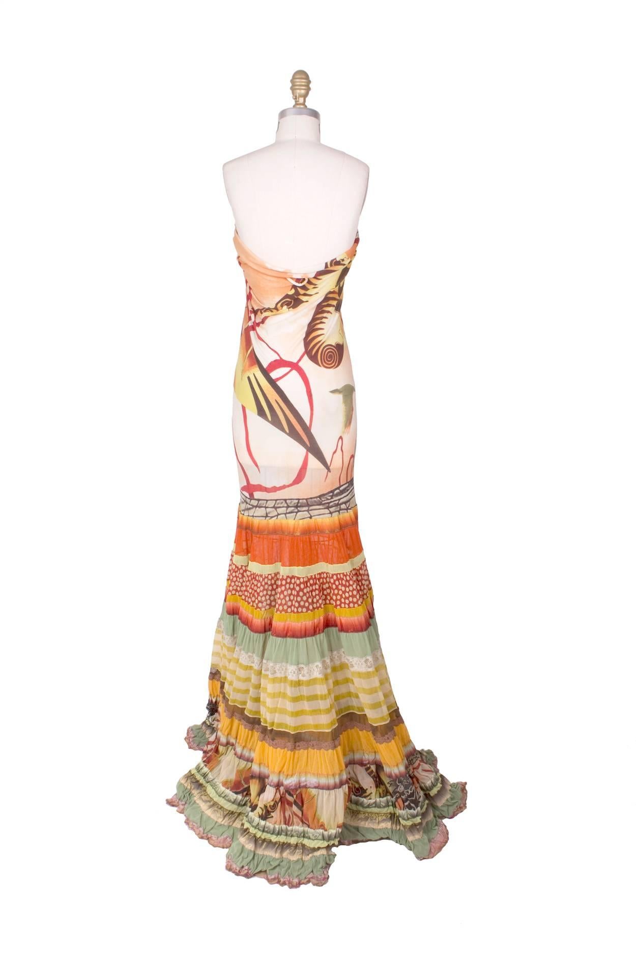 This is a dress by Jean Paul Gaultier, presumably from around the time of his spring 1994 Les Tatouages collection.  It features a stretch tube top with a multicolored/patterned ruffle skirt.  