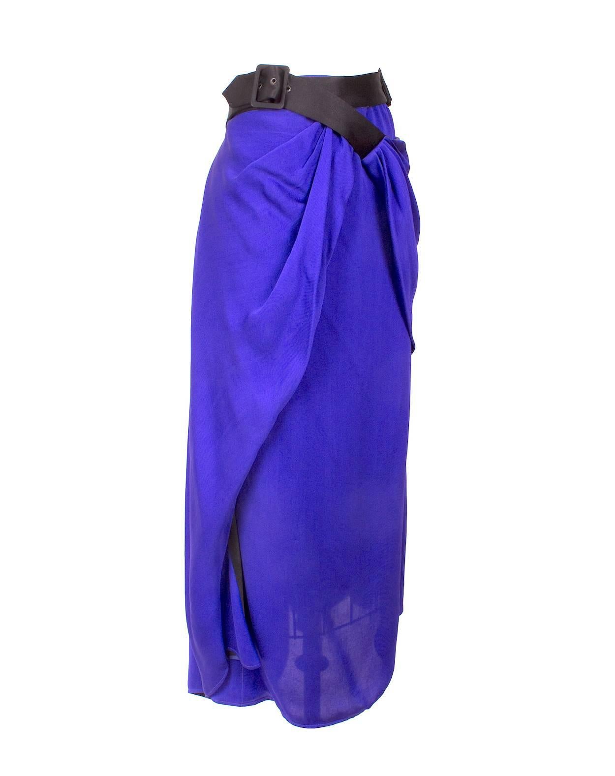 This is a purple silk skirt by Jean Paul Gaultier c. 1990s.  It has a wrap around design with a black belt and prong buckles.